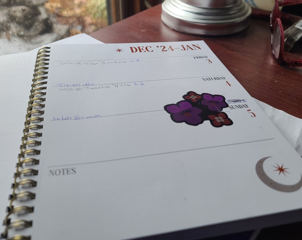 An image of a weekly planner with birthdays, events, and a mistake covered with a sticker and a scribble. 